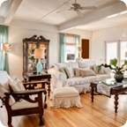 A living room with antique furniture and a China Cabinet.
